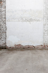 Broken old white plaster brick wall