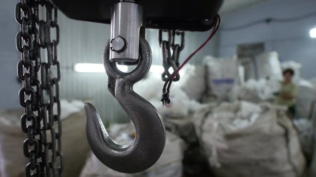 Industrial scales and metal chains on manufacturing warehouse