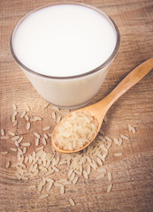 Rice milk on the wooden background .