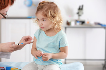 Doctor vaccinating child in clinic