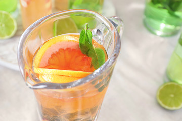 Jug with refreshing lemonade, closeup