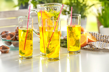 Glassware with refreshing lemonade on table outdoor