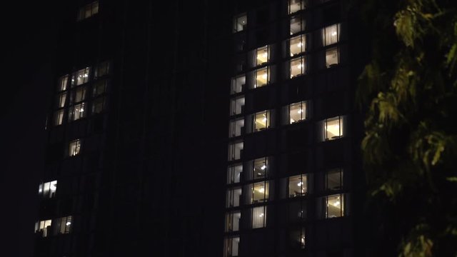 Building exterior in the evening with interior lights - abstract urban video background