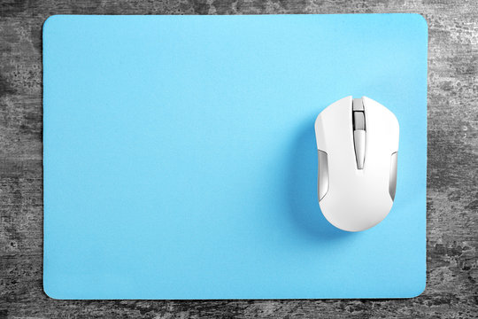 Blank mat and wireless mouse on textured background Stock Photo | Adobe  Stock
