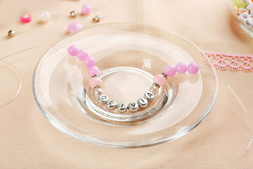 Bracelet with baby name OLIVIA on glass plate