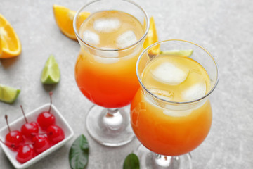 Glasses of delicious tequila sunrise cocktails on table