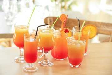 Glasses of delicious tequila sunrise cocktails on table