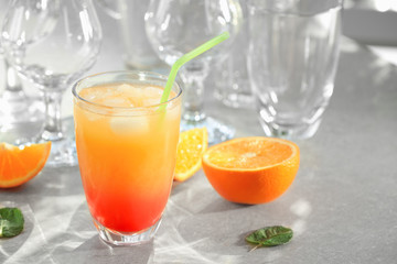 Glass of delicious tequila sunrise cocktail on table