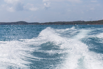 Sea waves caused by speedboats engine.