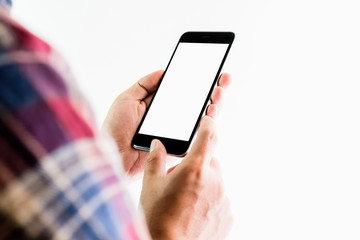 The man in a red plaid shirt stands holding a smartphone blank screen. Take your screen to put on advertising.
