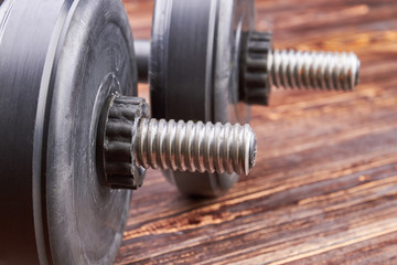 Close up of two metal dumbbells. Heavy object for fitness in gym.