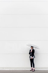 Obraz premium Fashionable young women with umbrella and bag