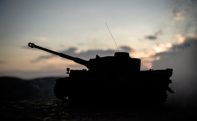 War Concept. Military silhouettes fighting scene on war fog sky background, World War German Tanks...