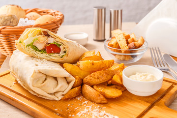 Shaurma on a wooden cutting board