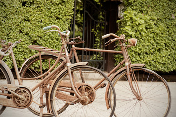 Fototapeta na wymiar Two Old bicycle in the garden Classic retro vintage tone.
