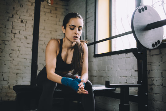 Young woman having some rest after hard workout in gym. - Powered by Adobe