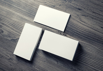 Photo of blank business cards on wooden table background. Template for ID. Mockup for branding...