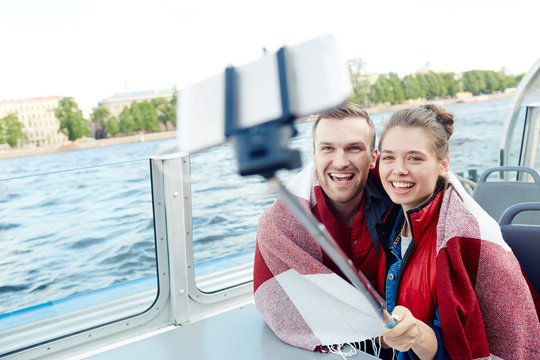 Couple with selfie-stick photographing on cruise tour