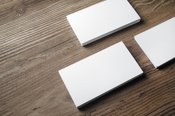 Blank white business cards on wood background. Mock-up for branding identity. Blank template for...