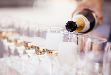 Bartender pouring champagne into glasses © kite_rin
