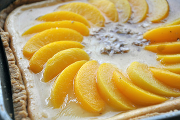 Homemade cheesecake with peaches close up.