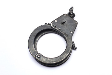 Old handcuffs on white background