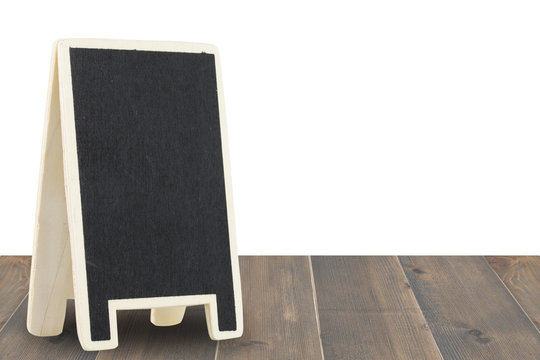 Black Board On Wood Table Isolated On A White Background