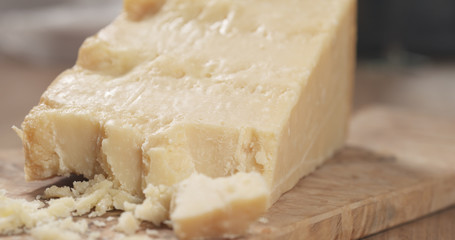 pieces of hard parmesan cheese on olive board