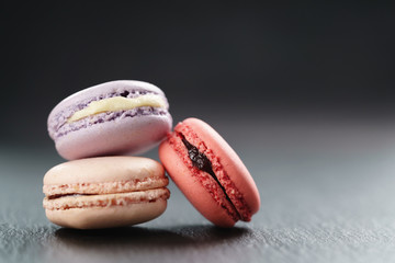 three mixed macarons on slate board