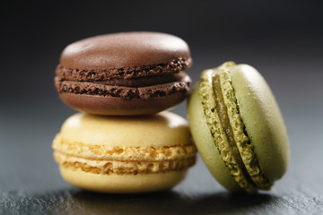 three assorted macarons on slate board