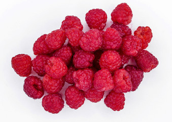 Heap of ripe raspberries on white