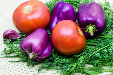 Assortment of fresh raw vegetables on a napkin. Selection includes tomato, green onion, pepper, garlic and dill