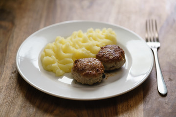 homemade cutlet with mashed potatoes on wood table