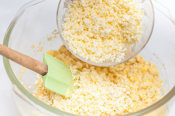 Traditional Colombian Arepa de Choclo Preparation : Adding shredded cheese