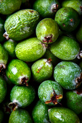 Feijoa Fruits. Fresh ripe sweet .Tropical fruit. Background of green color.Food or Healthy diet concept.Super Food.Vegetarian.Top View.Copy space for Text.selective focus.