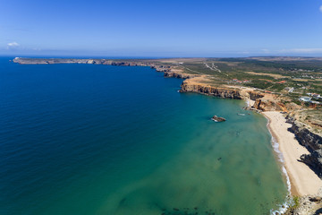 Aerial view of the Tonel Beach (Praia do Tonel) with the Saint Vincent Cape (Cabo de Sao Vincente) on the background, in Algarve, Portugal