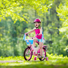 Naklejka premium Child riding bike. Kid on bicycle.
