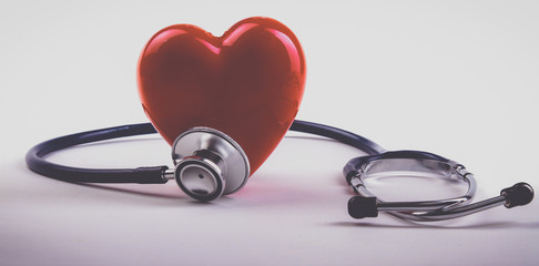 Red heart and a stethoscope on desk