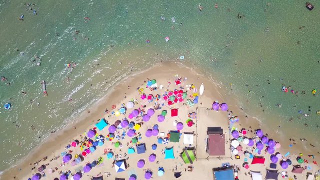 Tropical beach with colorful umbrellas - Top down aerial view