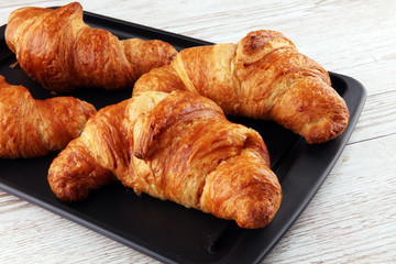 freshly baked croissants on white board, bakery concept