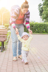 Fototapeta premium Baby first steps with mom