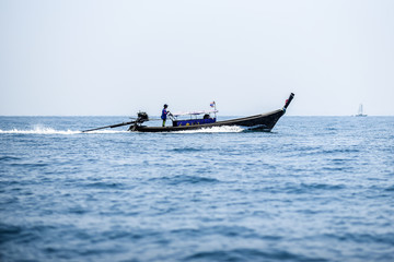 Long tail boat sailing on Andaman sea, Krabi Thailand.