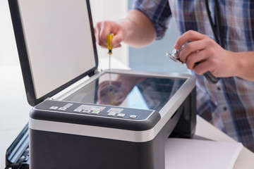 Repairman repairing broken color printer