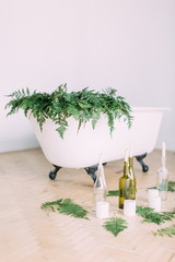 White bath decorated with fern and candles