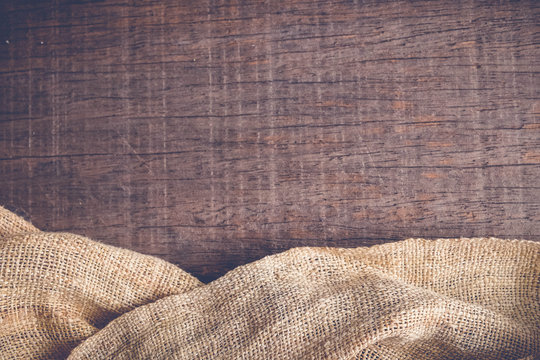 Wood table with old sackcloth burlap tablecloth texture with filter effect retro vintage style