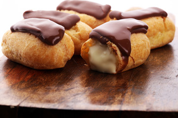 Traditional French dessert. Eclair with chocolate icing. Pastery concept