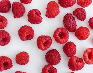 Ripe raspberries on a white plate