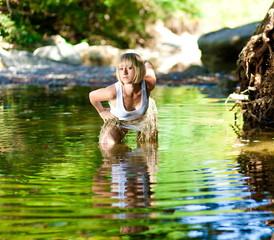 Woman in river. White t-shirt, fishnet