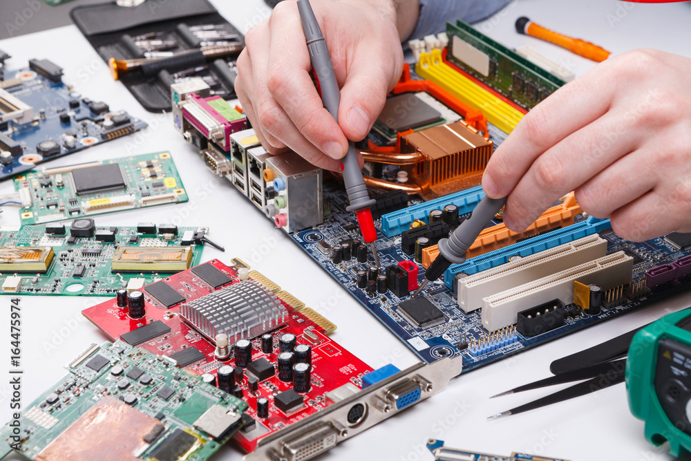 Aufkleber engineer checking motherboard with multimeter