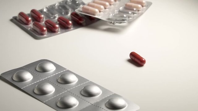 Capsule tablet falling and bouncing. On a white backgrounds